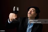 a-stereotypical-french-man-staring-at-a-glass-of-red-wine