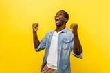 portrait-of-ecstatic-overjoyed-handsome-man-expressing-winning-gesture-indoor-studio-shot[1]