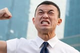 angry asian man about to punch himself in the face