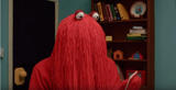 red spaghetti man with card