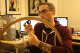 Josh_Sawyer_removing_spokes_from_a_bicycle_wheel