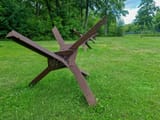 hedgehogs-anti-tank-obstacle-defense-line-czech-hedgehog-braces-steel-obstacles-grass-field-sunny-day-253853505-142295084