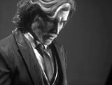 an-older-verso-sits-at-a-piano-in-clair-obscur