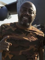 Donnell_Rawlings_stands_in_front_of_a_C-17_Globemaster_III_(32666816002)_(cropped)