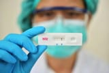 lab-technician-holding-hiv-rapid-device-test-the-result-showed-positive
