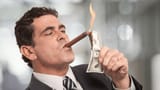 rich-guy-lighting-cigar-wuih-burning-money