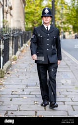 a-smartly-dressed-english-policeman-in-full-uniform-patrolling-on-HND2KD[1]