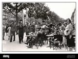 1940-paris-cafe-nazi-germany-occupation-boulevard-france-german-officers-of-the-nazi-wehrmacht-sitting-in-a-boulevard-cafe-on-a-street-in-central-paris-passing-german-soldiers-salute-the-seated-officers-with-parisians-going-about-their-day-