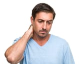 stressed-man-rubs-neck