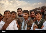 a-group-of-indian-men-crowd-together-and-pose-for-a-photograph-B2YMWK
