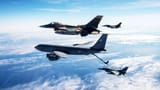 A 909th ARS KC-135R Stratotanker refuels F-16 Fighting Falcons near Guam during Exercise Cope North 2020.