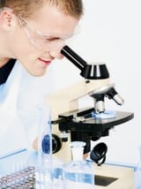 man-researching-microscope-11360135