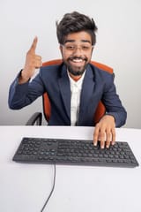 indian-man-glasses-working-computer-his-hands-hover-keyboard-while-typing-isolated-white-background-front-view_621325-1868