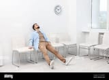 tired-man-sitting-on-chair-and-waiting-for-appointment-indoors-2X7KM5D