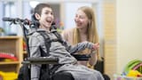 caregiver_sitting_alongside_student_mobility_disability_1200x675