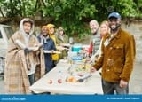 volunteers-helping-homeless-people-food-portrait-group-smiling-camera-arranging-charity-beggars-252894046