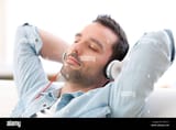 view-of-a-young-relaxed-man-listening-music-in-a-sofa-EXM7Y1