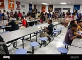 african-american-male-student-sits-alone-at-table-during-lunch-in-CRRPDW