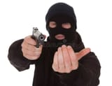 burglar-wearing-mask-holding-gun-aiming-towards-camera-34956077