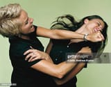 mature-businesswoman-punching-woman[1]