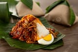 nasi-lemak-wrapped-in-banana-leaf-a-beloved-malaysian-breakfast-picture-image_11769390
