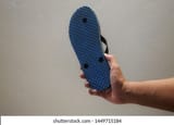 man-holding-flip-flop-sandal-260nw-1449715184