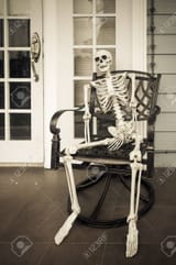 47668854-halloween-ghost-human-skull-sitting-on-chair-dramatic-style