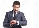 39094200-young-business-man-looking-at-watch-over-white-background_jpg