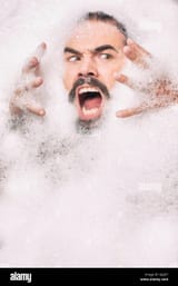 man-with-moustache-covered-in-bubbles-pulling-face-GJ2J5Y-1541350642