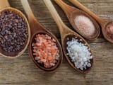 a-variety-table-salts-and-sea-salts-on-wooden-spoons-533413262