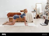 young-woman-arching-her-back-on-her-knees-and-resting-her-palms-on-the-floor-2H24KF6