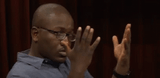 Hannibal Buress looking at hands