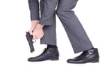 businessman-shooting-himself-in-the-foot-with-a-handgun[1]