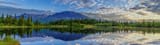 Blue Sky With Scattered Clouds Reflected In The Lake