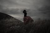 girl-storm-dress-field-clouds