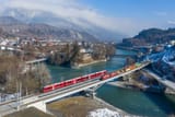 RhB_Ge_4-4_I_with_freight_and_ABe_4-16_as_S-Bahn_at_Reichenau-Tamins
