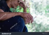 stock-photo-a-man-feeling-stress-from-smoking-cigarette-1073953763