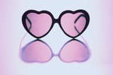 rose-colored-glasses-sit-on-reflective-background