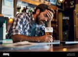 sad-man-sitting-in-beer-bar-TRC4RP