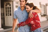 woman-walking-on-street-with-her-boyfriend-holding-him-with-her-arms-around-his-waist-man-walking-with-his-girlfriend-on-street-with-arm-around-her-shoulder-JLPSF16778