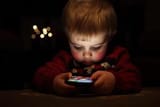 a-child-playing-with-a-cell-phone-photo